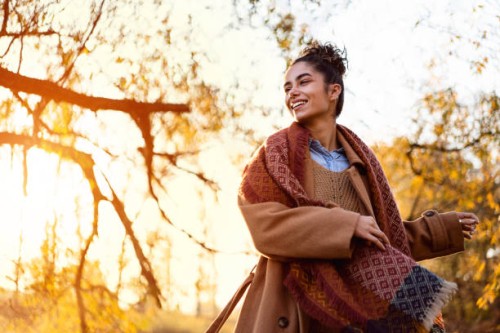 beautiful young woman enjoying a carefree autumn day outdoors - fashion stock pictures, royalty-free photos & images