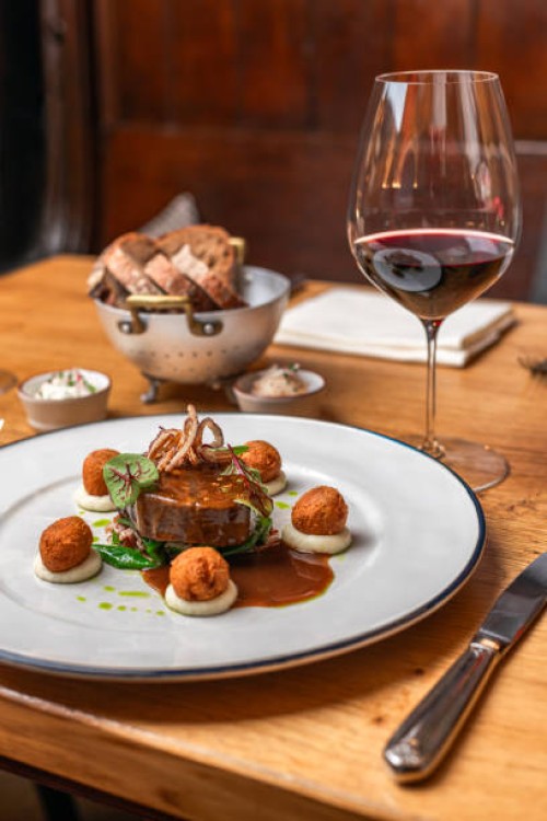beef deer steak filet with fried sweetbread and gravy served with red wine at michelin star gourmet restaurant - food stock pictures, royalty-free photos & images