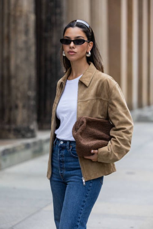 Bella Emar wears Levi’s blue denim jeans, white Cos t-shirt, brown Massimo Dutti Jacket during the Berlin Fashion Week SS25 on July 01, 2024 in...