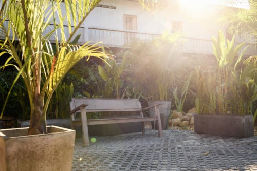 bench in a tropical home garden - garden decoration stock pictures, royalty-free photos & images