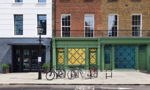 bicycles on bike racks along sidewalk in residential area of london, england - fashion stock pictures, royalty-free photos & images