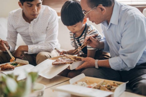 big family eating take-out food together - junk food stock pictures, royalty-free photos & images