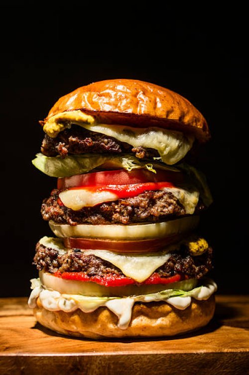 big hamburger on black - junk food stock pictures, royalty-free photos & images