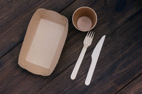 biodegradable disposable tableware made of recyclable plastic and paper on wood background or table. the concept of protection, care and environmental protection. life without plastic - junk food stock pictures, royalty-free 