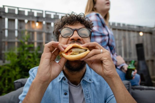 biting into a burger - food stock pictures, royalty-free photos & images