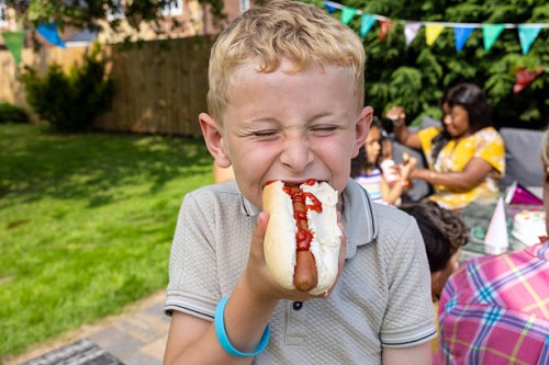 biting into delicious hot dog - junk food stock pictures, royalty-free photos & images