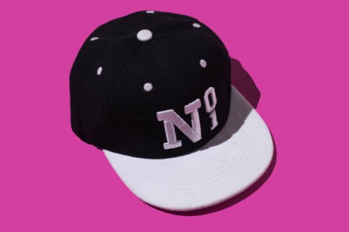 black and white baseball cap with text 'no 1', on pink background. concept of fashion, clothing, accessories, hip hop, baseball, sport, uniform and sun protection. - fashion stock pictures, royalty-free photos & images