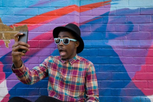 black man taking selfie near colorful wall - fashion stock pictures, royalty-free photos & images