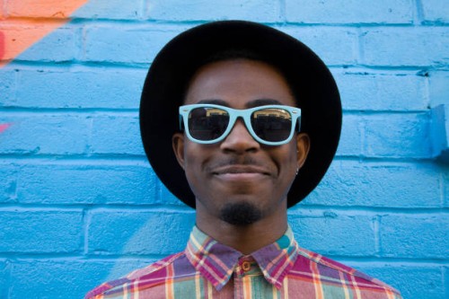black man wearing sunglasses near colorful wall - fashion stock pictures, royalty-free photos & images