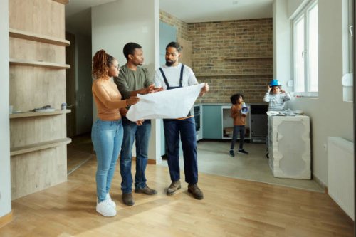 black parents and manual worker analyzing blueprints in the apartment. - home decoration stock pictures, royalty-free photos & images