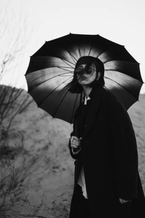 black white photography. redhead girl in black clothes outdoors. gothic style. asian fashion model in dark coat with umbrella on nature. bw photo. stylish outfit. subculture. monochrome. desaturated - fashion stock pictures, 