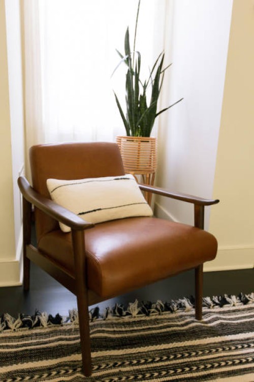 boho chic leather chair with midcentury modern style in stylish living room home interior - home decoration stock pictures, royalty-free photos & images