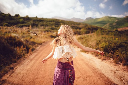 boho girl on a country dirt road being joyful - fashion stock pictures, royalty-free photos & images