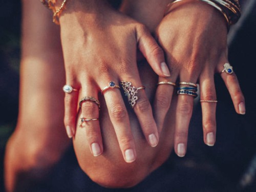 boho girl's hands looking feminine with many rings - fashion stock pictures, royalty-free photos & images