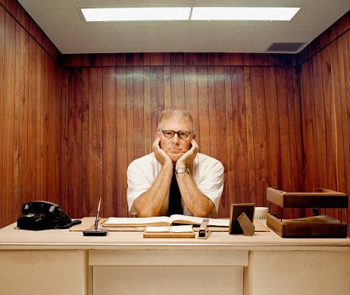 bored man sitting at desk - hairstyle stock pictures, royalty-free photos & images