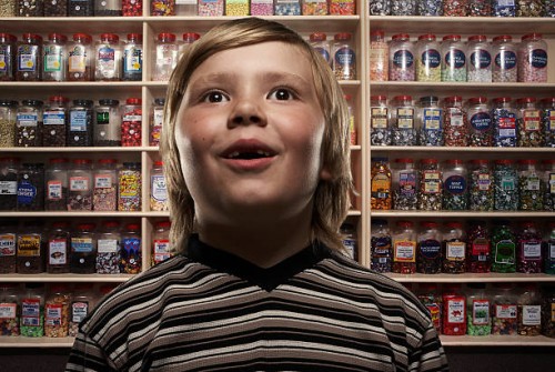 boy (6-8) in sweetshop, close-up (digital composite) - junk food stock pictures, royalty-free photos & images