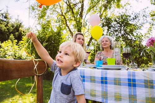 boy at table with family of three generations in garden - garden decoration stock pictures, royalty-free photos & images