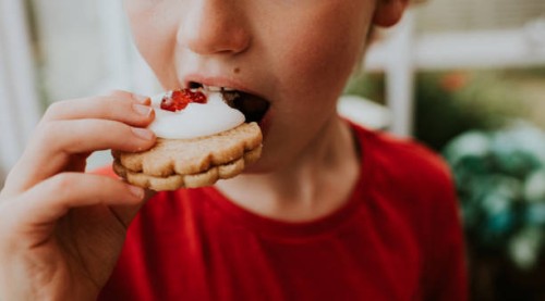 boy eating a german biscuit - food stock pictures, royalty-free photos & images