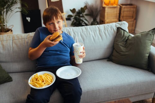boy eating junk food at home - junk food stock pictures, royalty-free photos & images