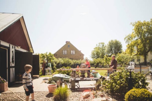 boy looking at grandparents doing carpentry in yard against clear sky - home decoration stock pictures, royalty-free photos & images