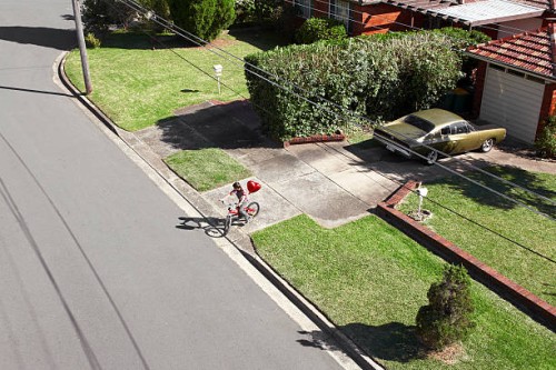 boy on bike with red heart shaped balloon - garden decoration stock pictures, royalty-free photos & images