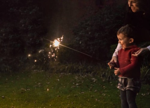 boys holding spraklers for new year's eve - garden decoration stock pictures, royalty-free photos & images