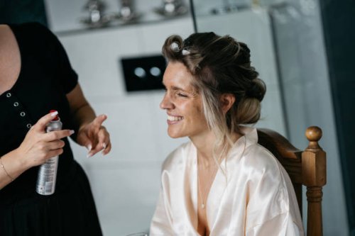bride getting ready for wedding with stylist using hairspray and curlers - hairstyle stock pictures, royalty-free photos & images