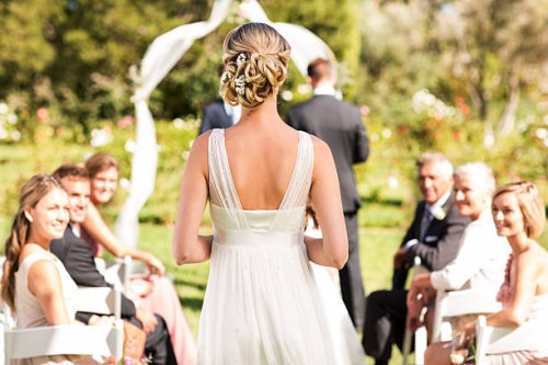 bride walking down the aisle during wedding ceremony - hairstyle stockfoto's en -beelden