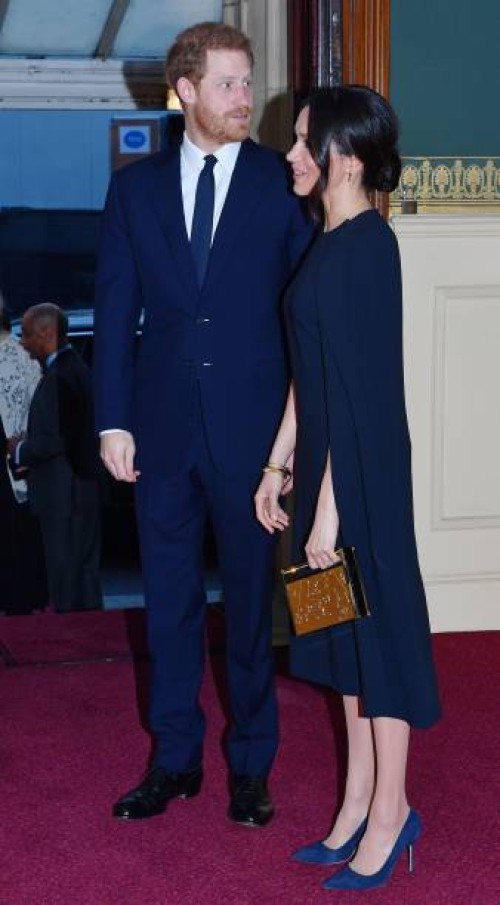 Britain's Prince Harry and his US fiancee Meghan Markle attend The Queen's Birthday Party concert on the occassion of Her Majesty's 92nd birthday at...