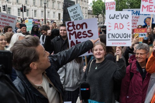 British celebrity chef and healthy food campaigner Jamie Oliver speaks during a protest outside Downing Street against the government's U-turn on its...