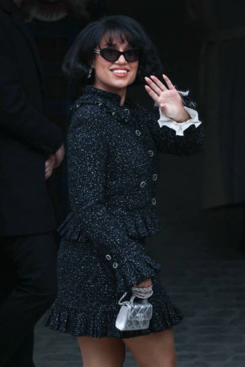 British singer and songwriter Raye waves as she arrives to attend the presentation by Chanel for the Womenswear Ready-to-wear Fall-Winter 2025/2026...