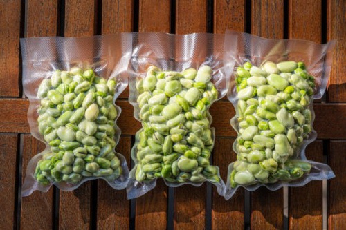 broad beans also lima beans peeled in vacuum sealed plastic bag ready to be frozen - food stock pictures, royalty-free photos & images
