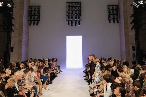 Brooklyn Beckham, David Beckham, and Anna Wintour stand for a moment of silence honoring the victims of the 9/11/2001 terrorist attacks before the...