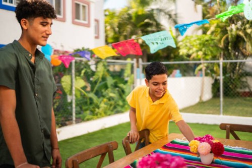 brothers talking and preparing house to party - garden decoration stock pictures, royalty-free photos & images