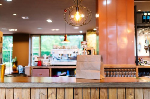 brown paper bag kept on restaurant counter - junk food stock pictures, royalty-free photos & images