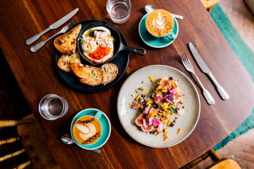 brunch at the cafe with shakshouka and fog toast decorated with flowers, top view - food stockfoto's en -beelden
