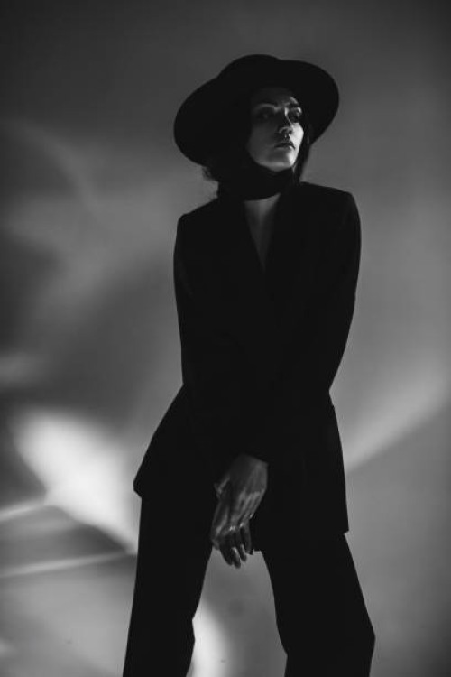 brunette woman in black suit and hat in studio. retro style - fashion stock pictures, royalty-free photos & images