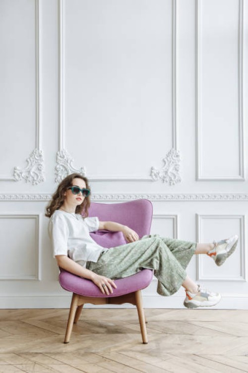 brunette woman model in sunglasses posing in studio sitting on armchair catalog - home decoration stock pictures, royalty-free photos & images