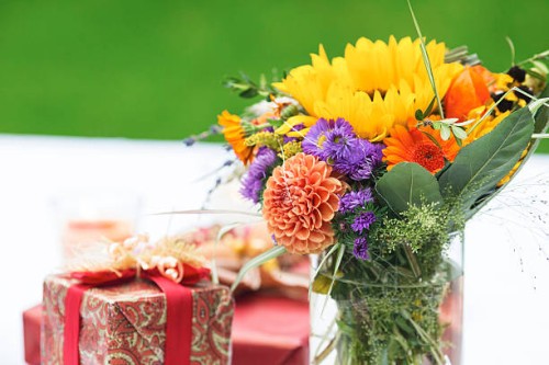 bunch of flowers and gift on outdoor table - garden decoration stock pictures, royalty-free photos & images