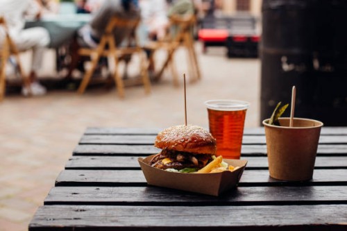 burger on a wooden table outdoor - junk food stock pictures, royalty-free photos & images