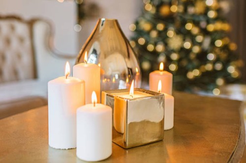 burning golden candles living room christmas decoration, christmas background, white and gold colors, winter holidays background, interior - home decoration stock pictures, royalty-free photos & images