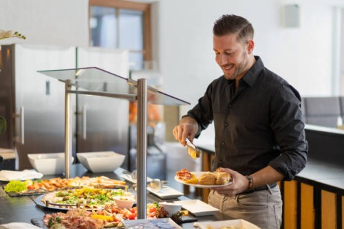 business man at hotel restaurant buffet - food stock pictures, royalty-free photos & images