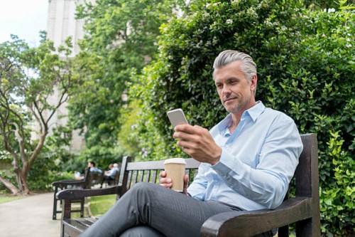 business man texting on his phone - junk food stock pictures, royalty-free photos & images