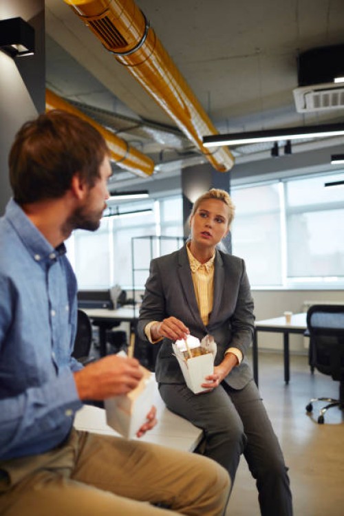 business people eating in their office - junk food stock pictures, royalty-free photos & images