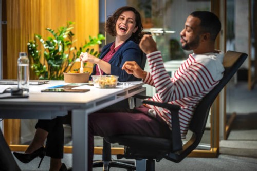 business people laughing on table - food stockfoto's en -beelden