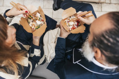 business people taking a break and eating poke with take out box - junk food stock pictures, royalty-free photos & images