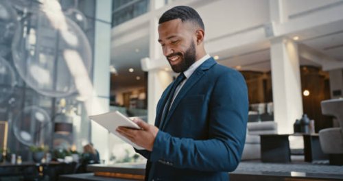 businessman, digital tablet or strategy planning in hotel conference lobby or airport travel lounge. happy smile, corporate worker or technology app to budget company finance or schedule target goals - travel stock pictures, 