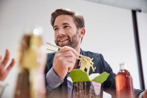 businessman having lunch break with asian food - junk food stock pictures, royalty-free photos & images