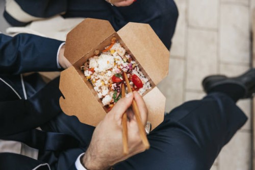 businessman taking a break and eating poke with take out box - junk food stock pictures, royalty-free photos & images
