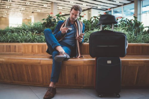 businessman using online banking at the airport - travel stock pictures, royalty-free photos & images